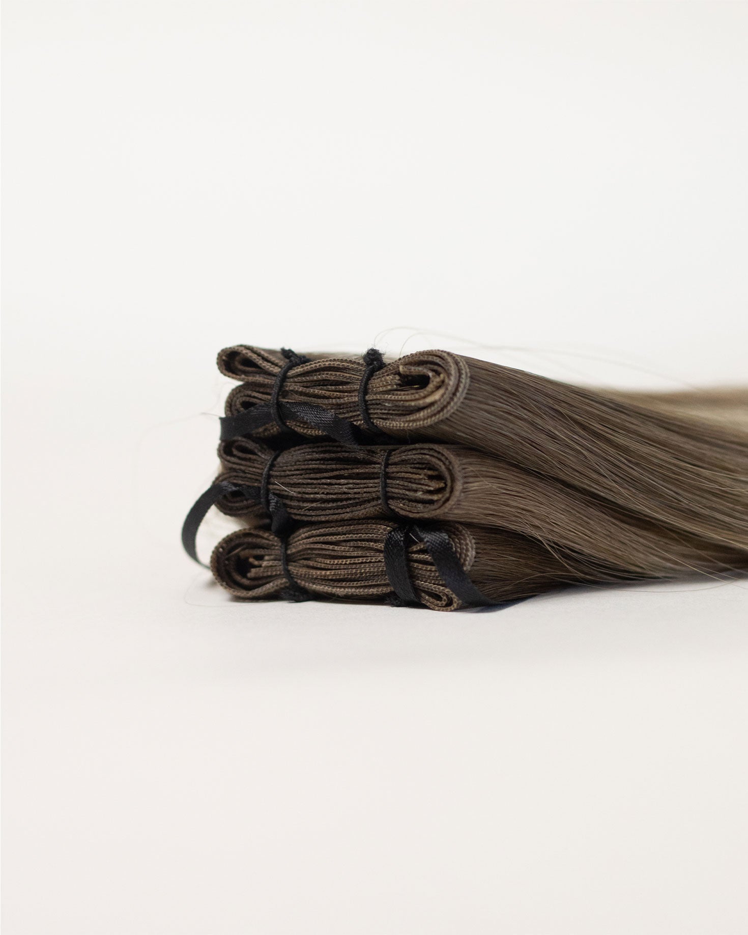 Folded Vera Hair Co micro-tied wefts showing compact, moisture-resistant seams for simplified professional installation