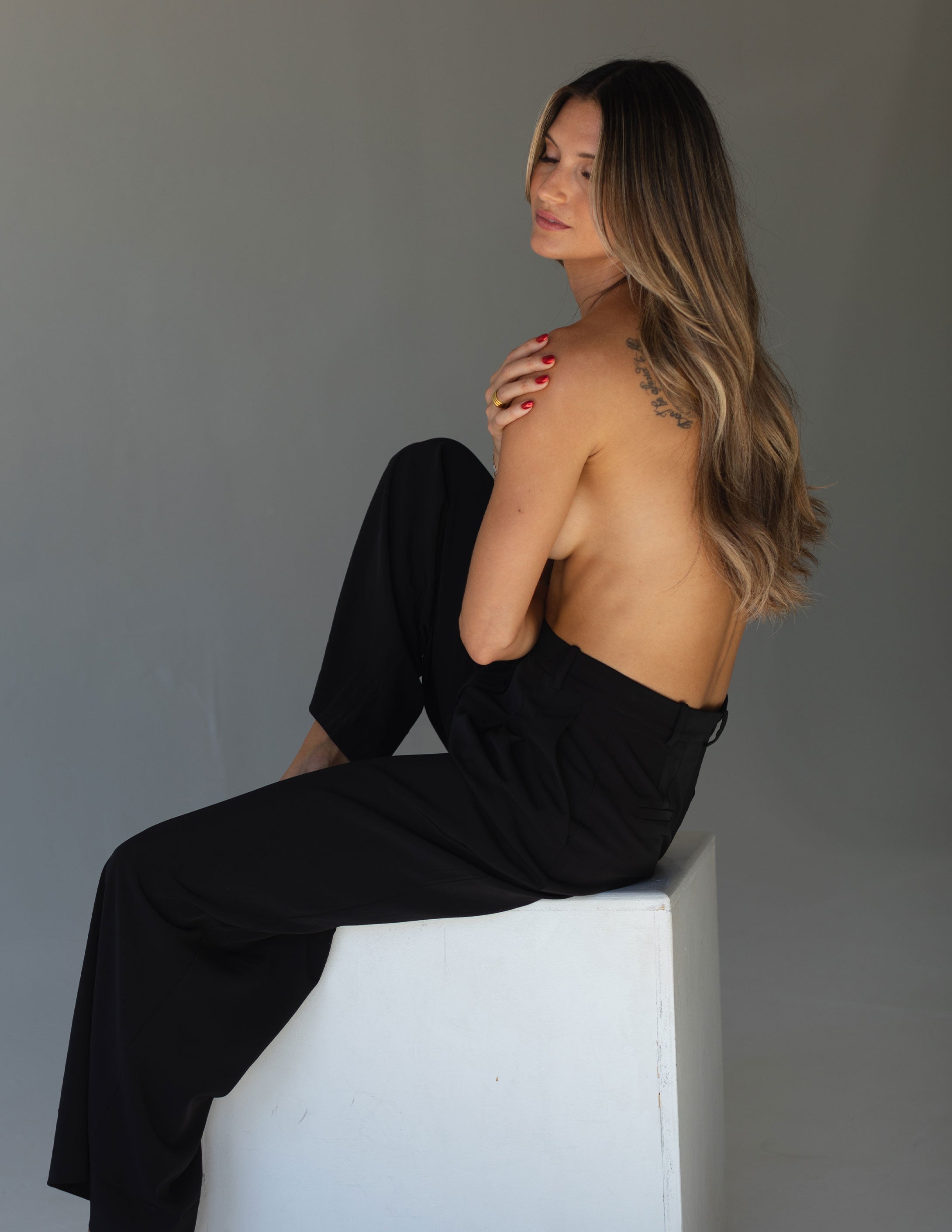 Model showcasing long, healthy Vera Hair Co micro-tied wefts styled in soft waves, emphasizing natural extension texture and shine