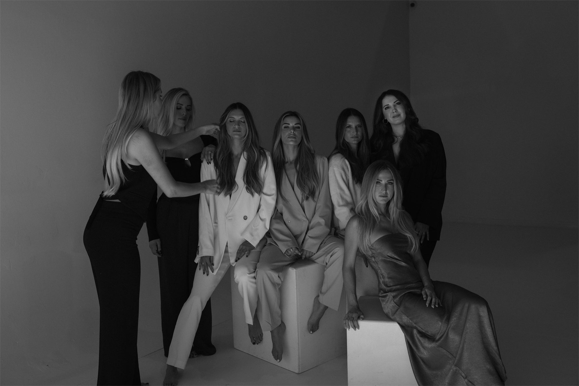 Maeghen Soucinek, founder of Vera Hair Co, styling micro-tied extensions on models during a brand photoshoot