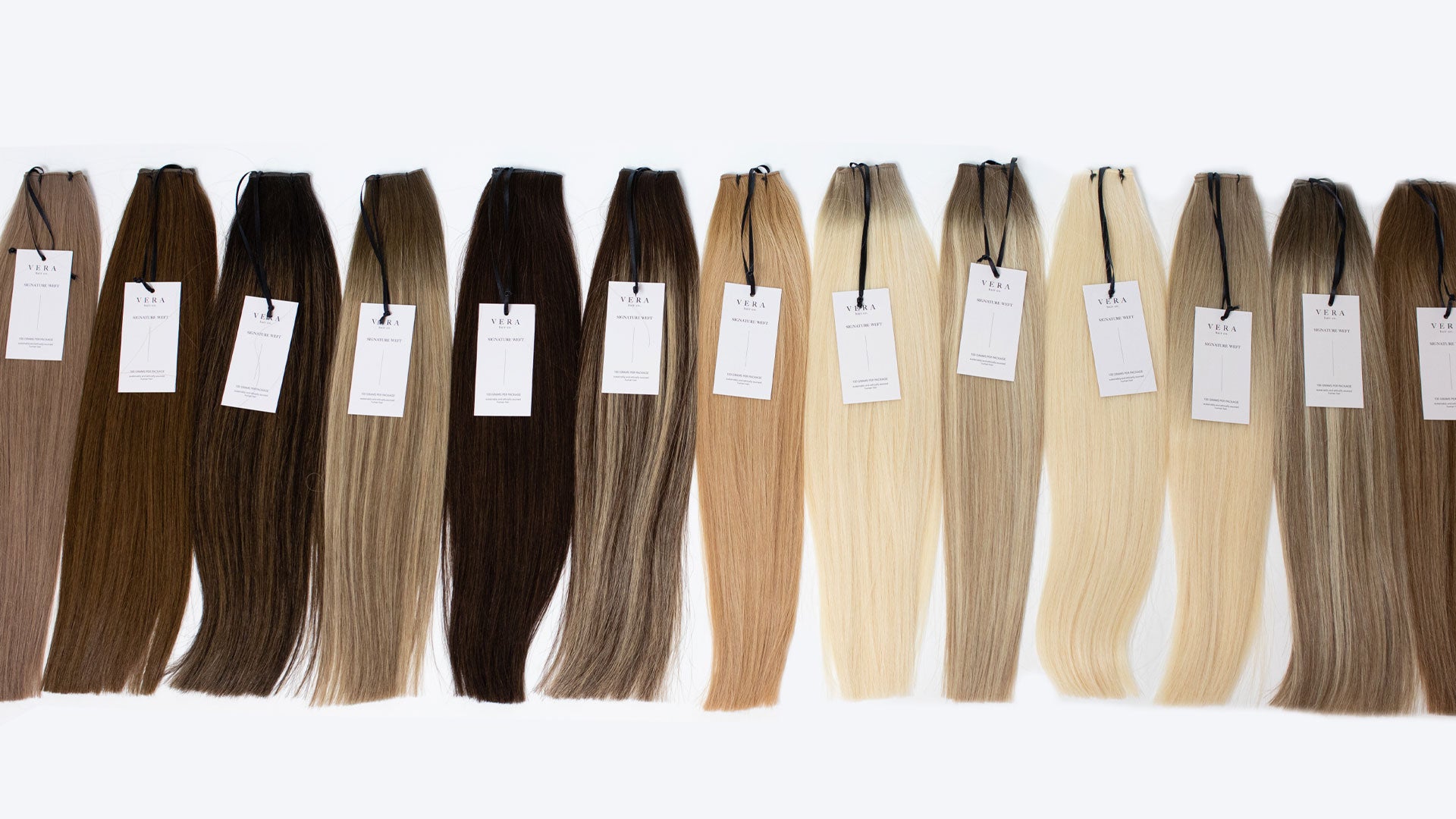 Full lineup of Vera Hair Co signature micro-tied weft color swatches showcasing pre-blended, double drawn Remy hair for licensed stylists