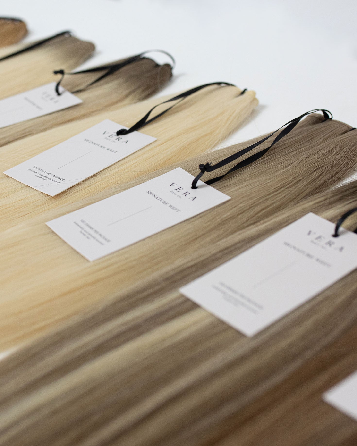 Vera Hair Co signature weft color swatches showcasing pre-blended Remy hair shades for licensed stylists